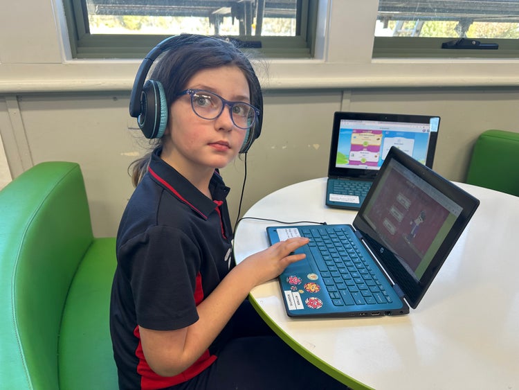 A student using a laptop to develop their technology skills.