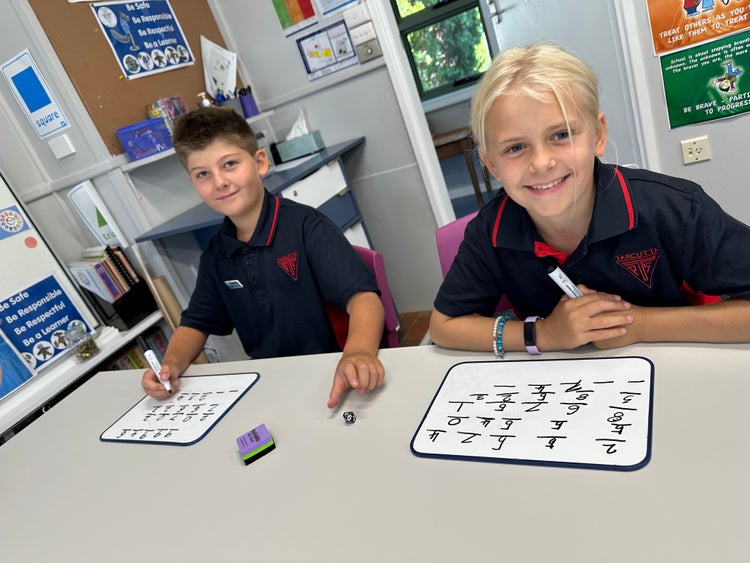 Two primary students playing a maths games.