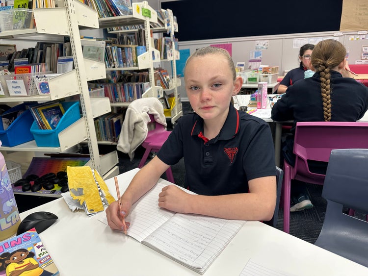 Student learning at her desk.
