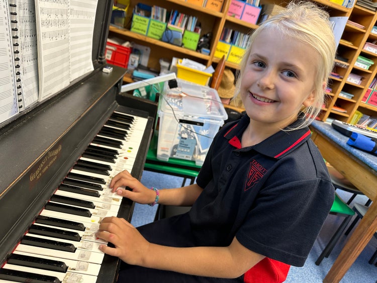 A student playing the piano.