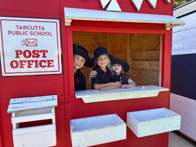 Children playing in a school cubby house.
