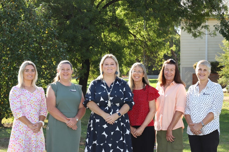 Photo of the school staff in the playground.