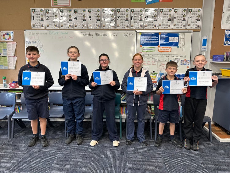 Students showing their achievement certificates for Public Speaking.