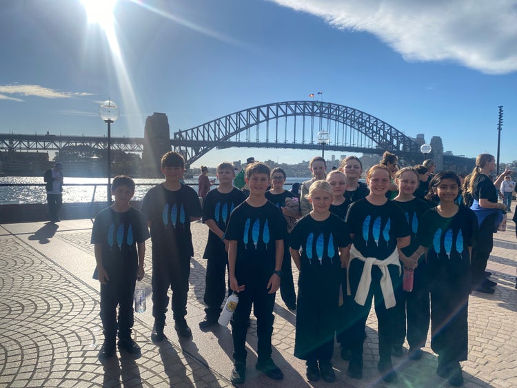 Students in front of Sydney Harbour Bridge after completing performing their recorders at the Sydney Opera House.